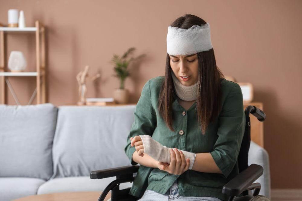 Woman in a wheelchair with a head cast