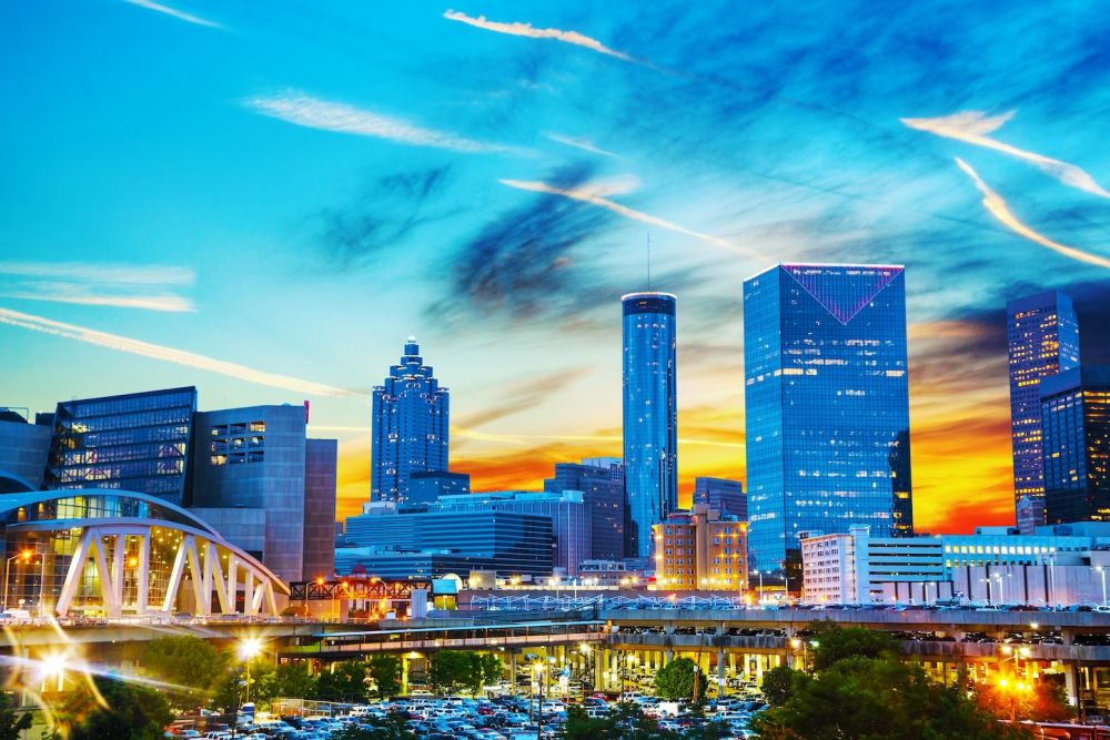 Vibrant Atlanta skyline at sunset with iconic buildings and colorful sky, showcasing urban architecture and cityscape.